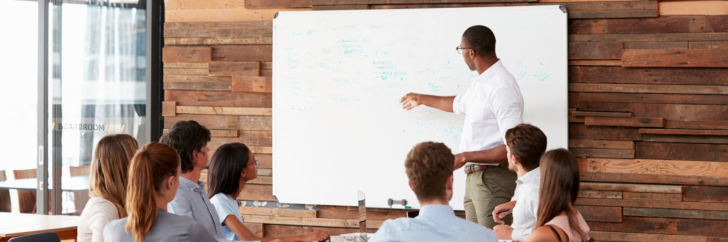 bigstock-Young-black-man-at-whiteboard--183817627